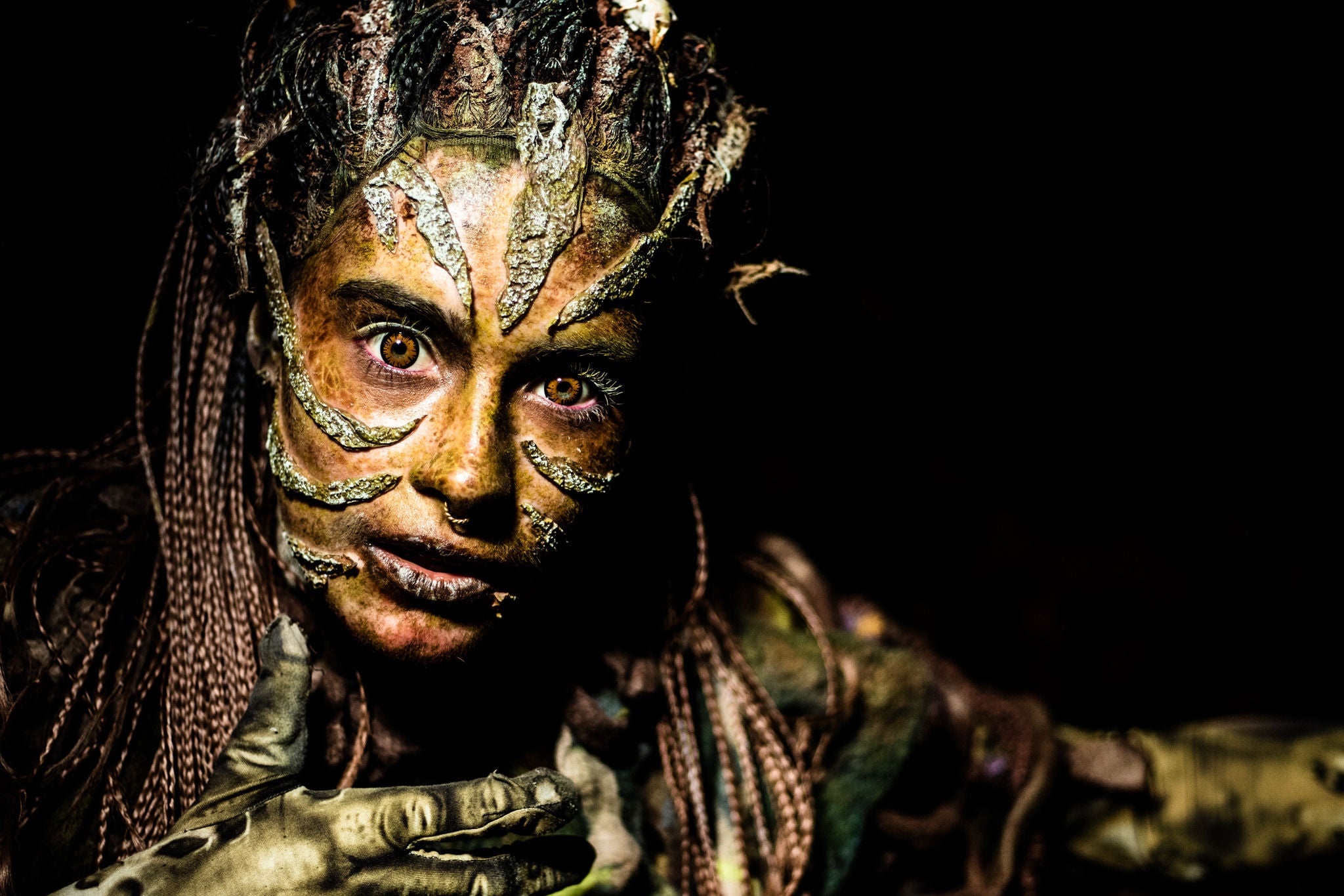 A girl is having growing plants on her face