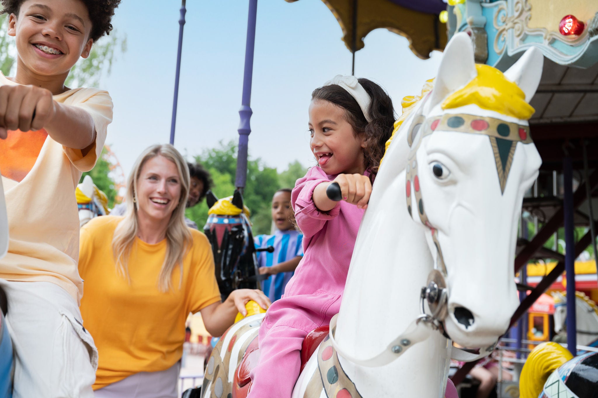 A little girl is riding a poney from the attraction Merrie go'round of Walib Holland