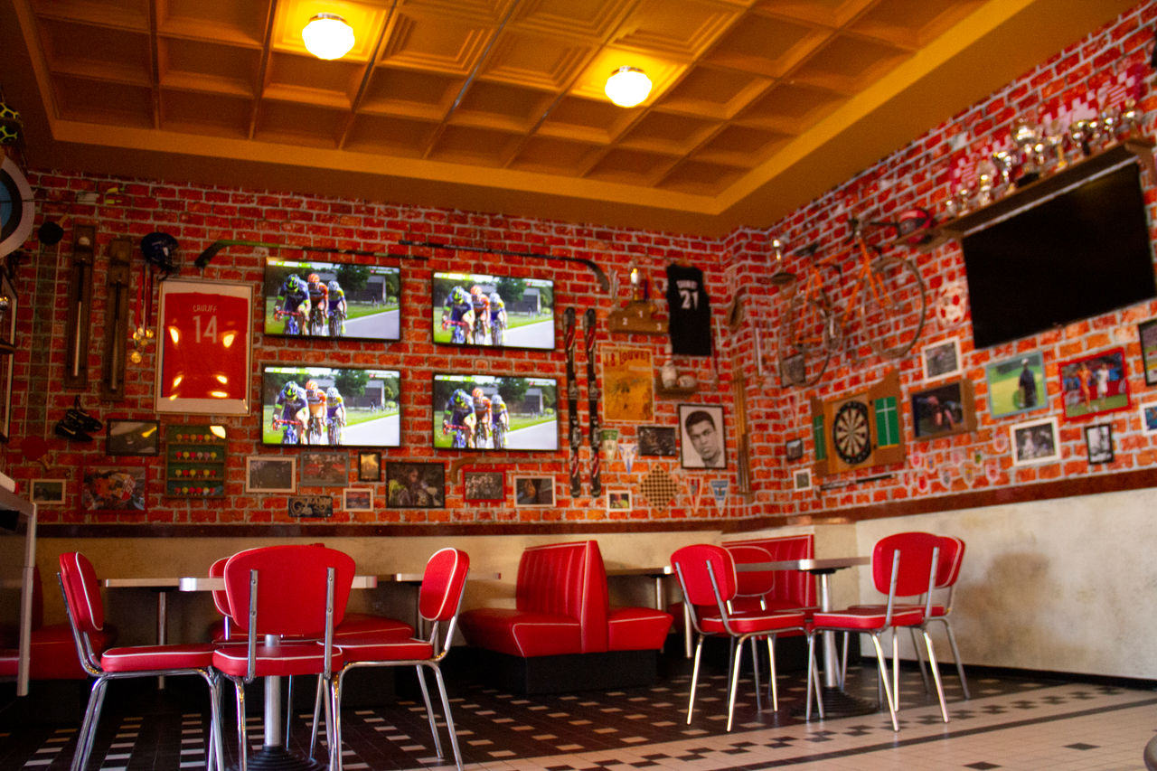 American café interior with red chaires and tables 